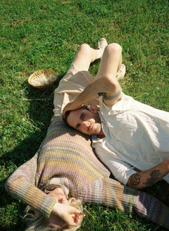 Couple lying on grass, enjoying relaxation and wellness benefits from Stho’s collagen and MSM supplements