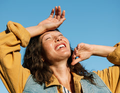 Girl smiling in the sun, radiating natural beauty with the benefits of Stho collagen and MSM